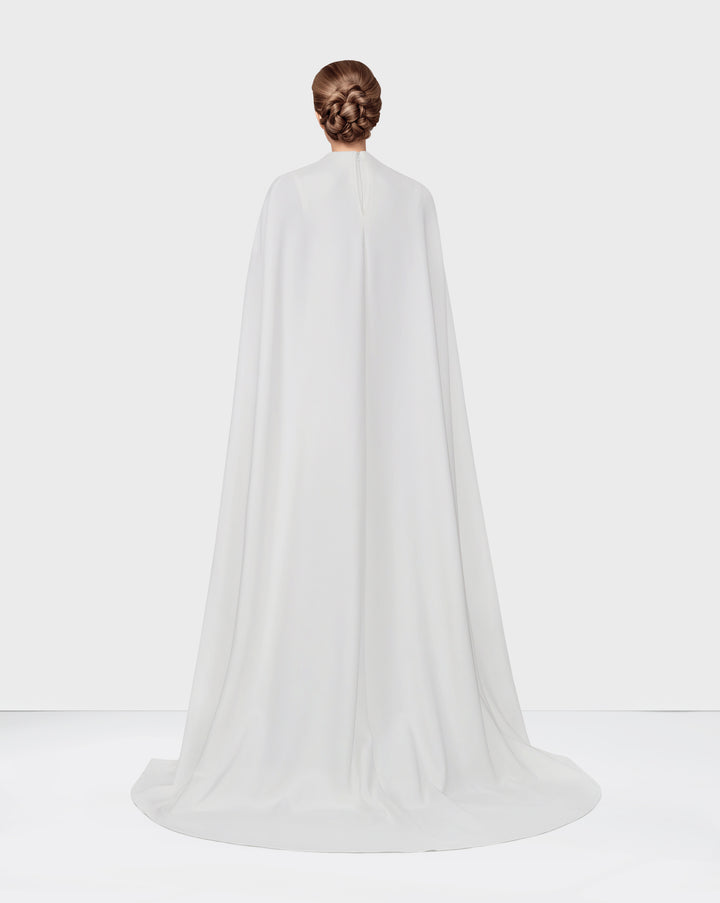 White dress with neckline and cape