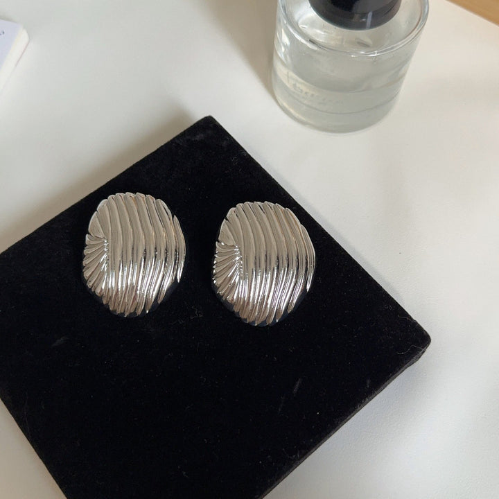 textured oval stud earrings with metallic finish - LYRANU